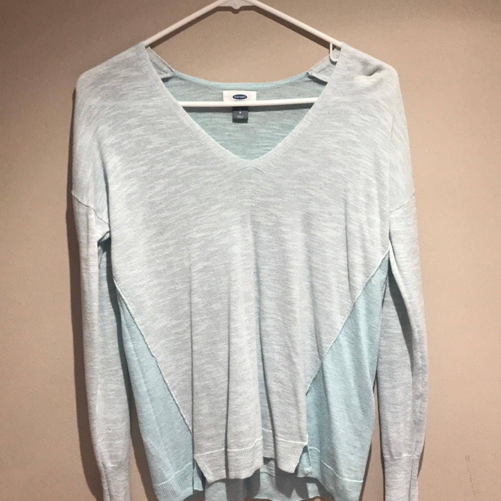 Two-toned teal blue sweater.